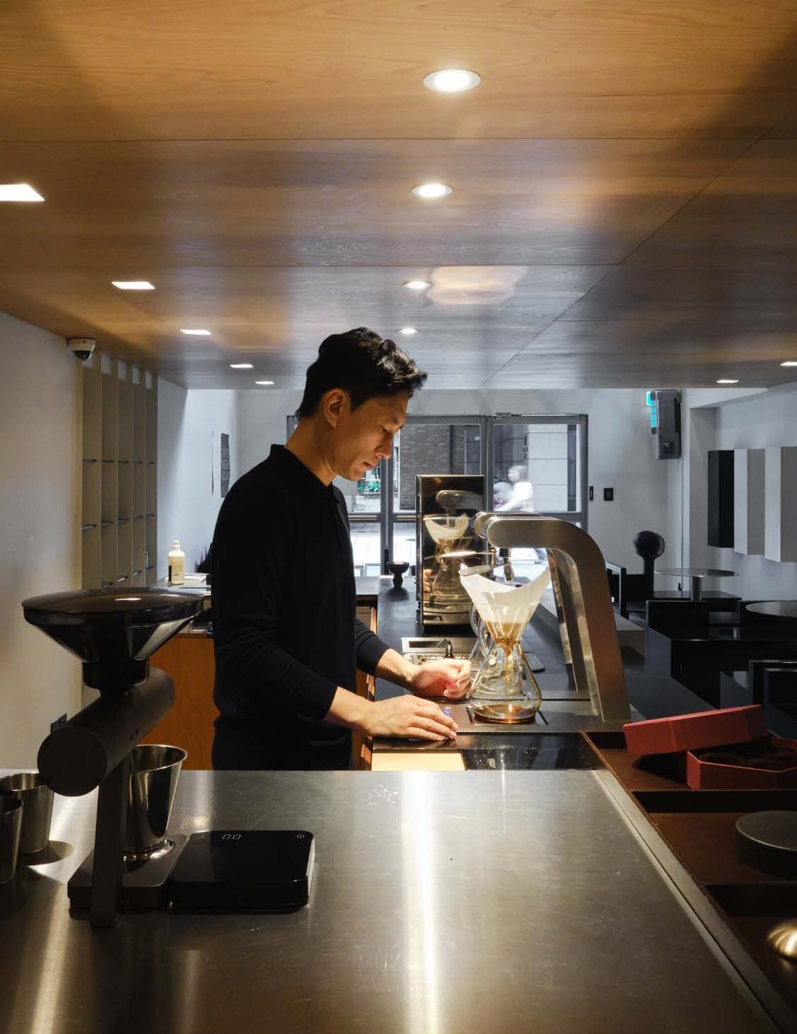 A coffee specialist preparing a precise pour in Seoul