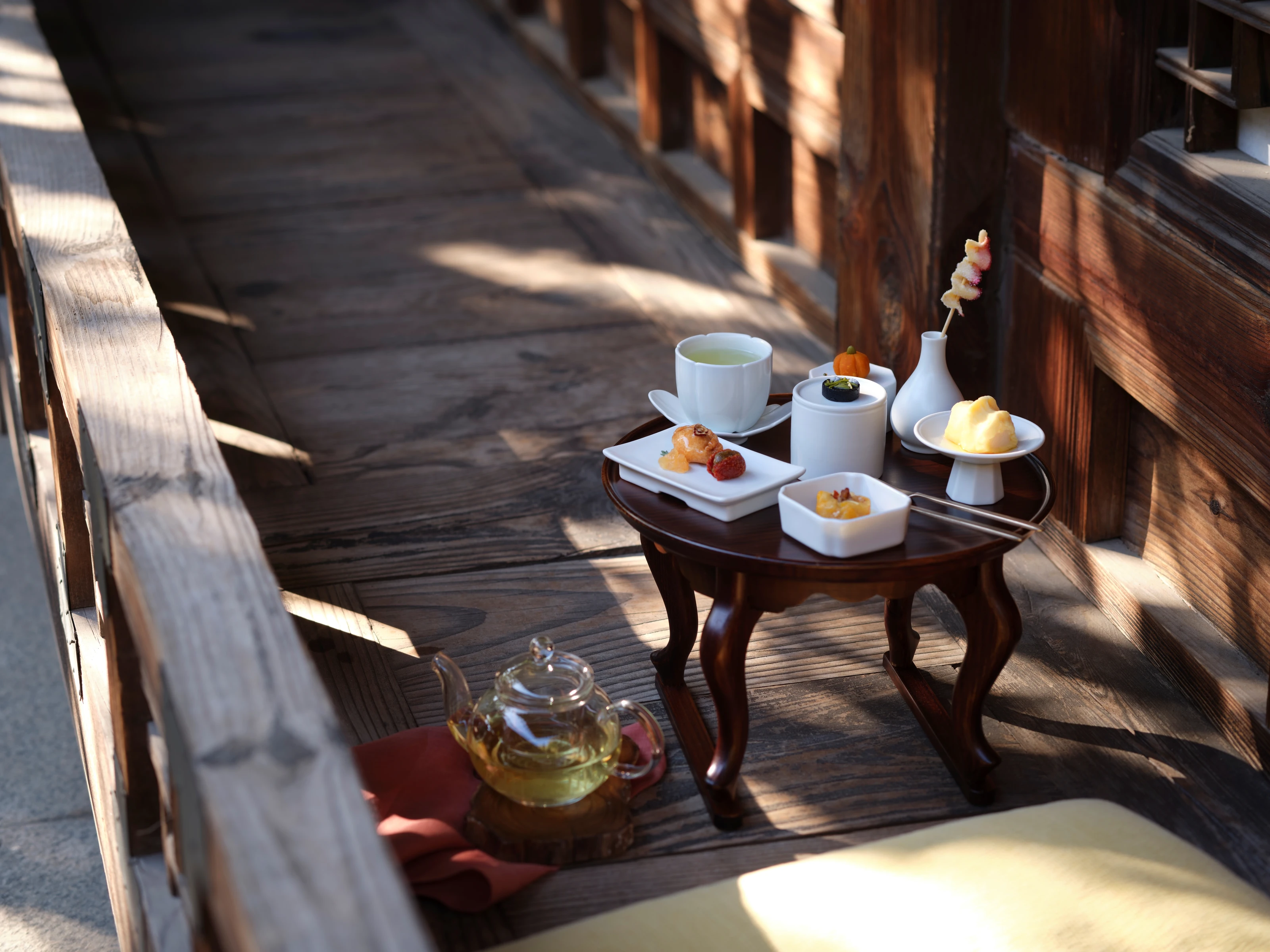 Traditional Korean tea and confections on a wooden table in warm natural light