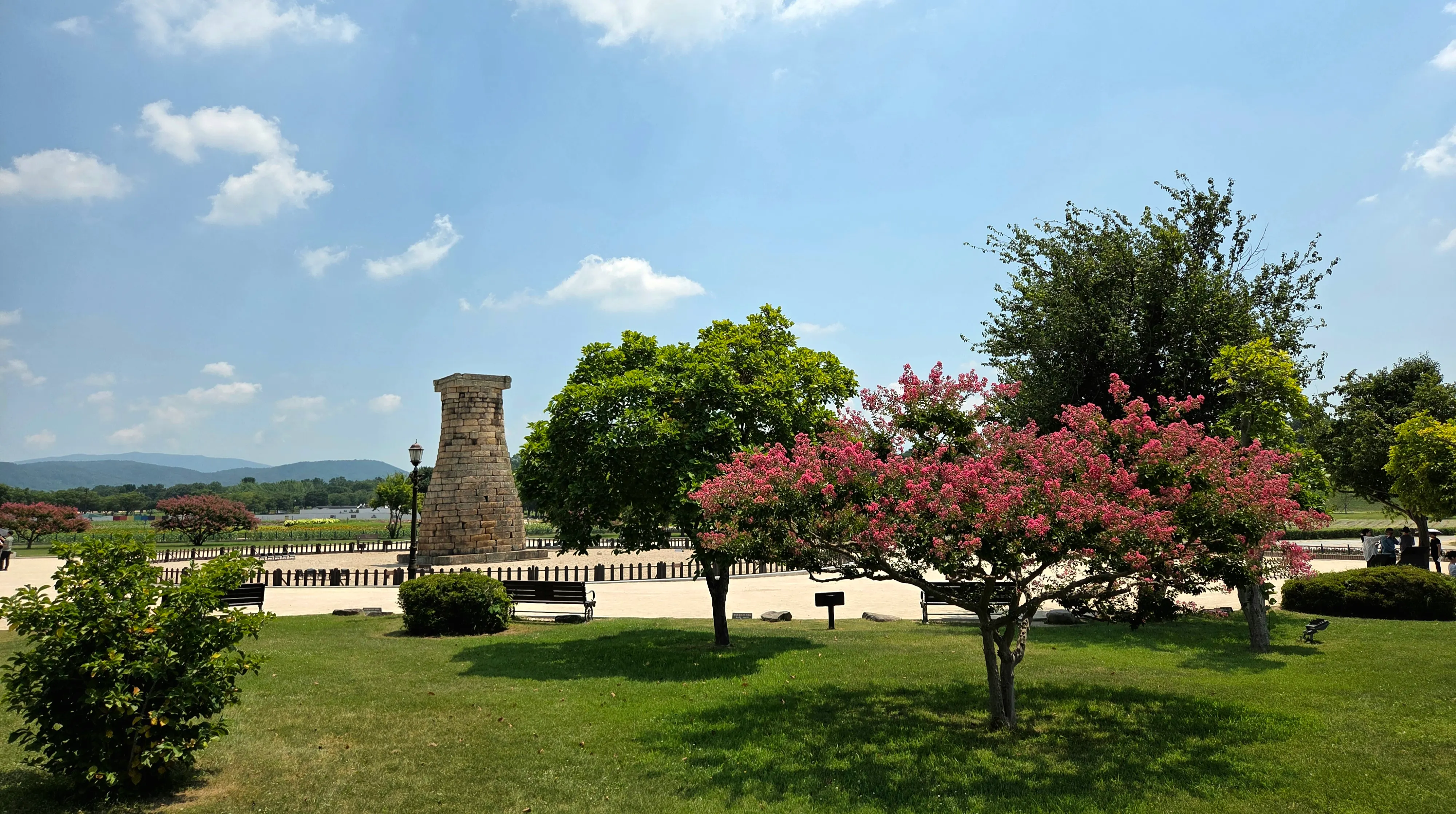 Cheomseongdae surrounded by trees and open lawn